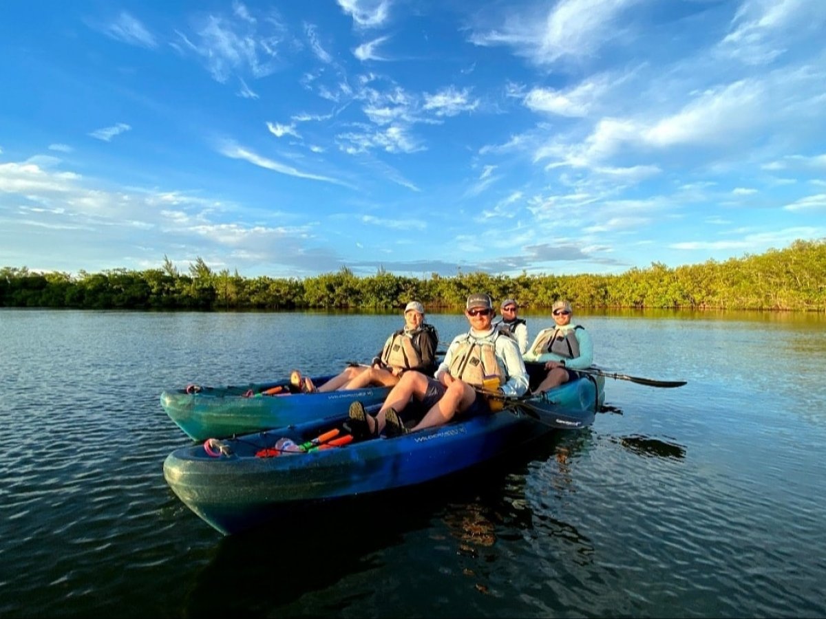 a group of people in a small boat in a body of water