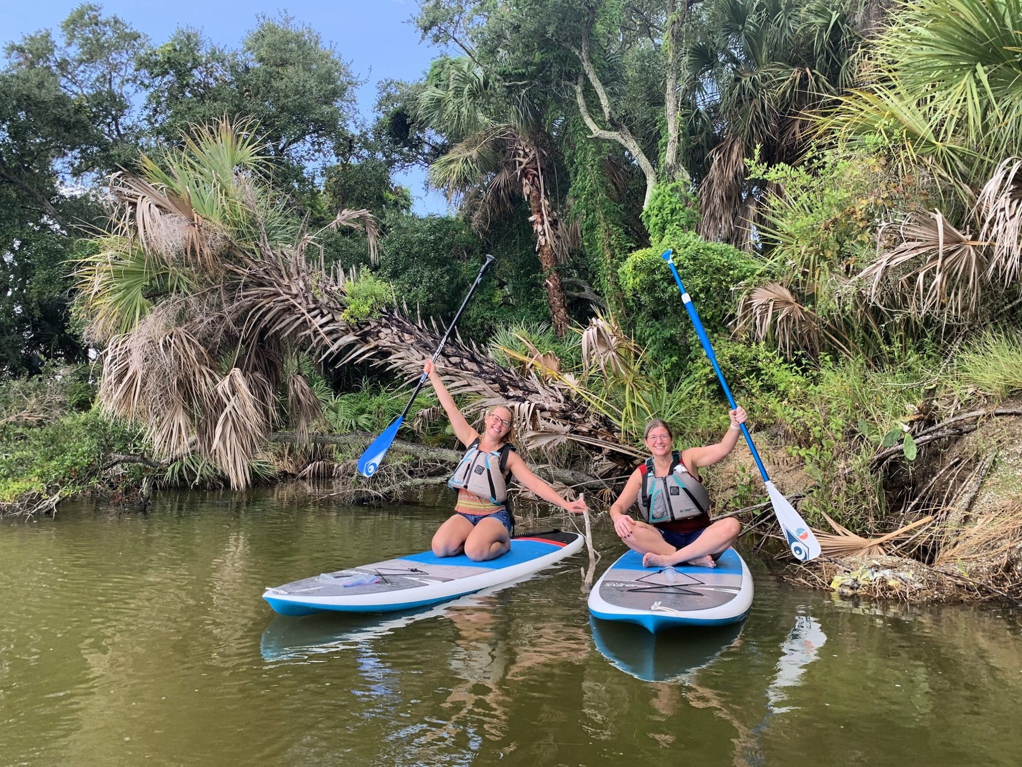 a group of people riding on the back of a boat in the water