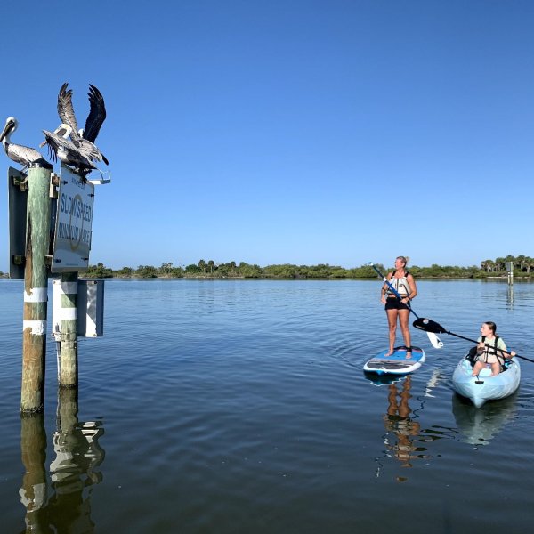 a person standing next to a body of water