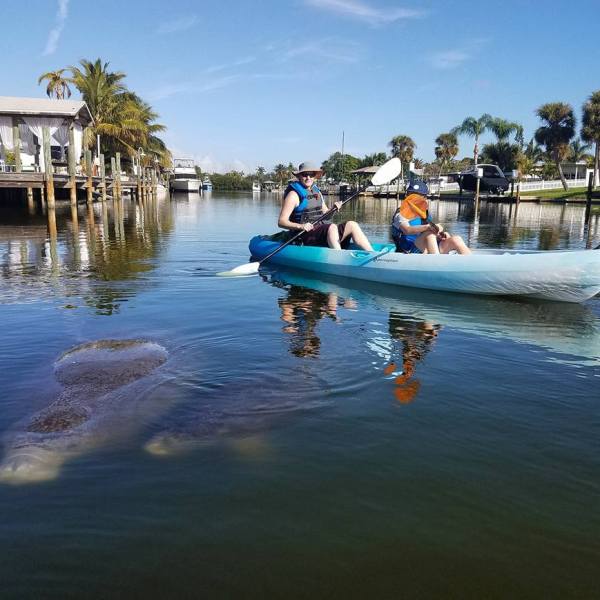 a group of people in a small boat in a body of water