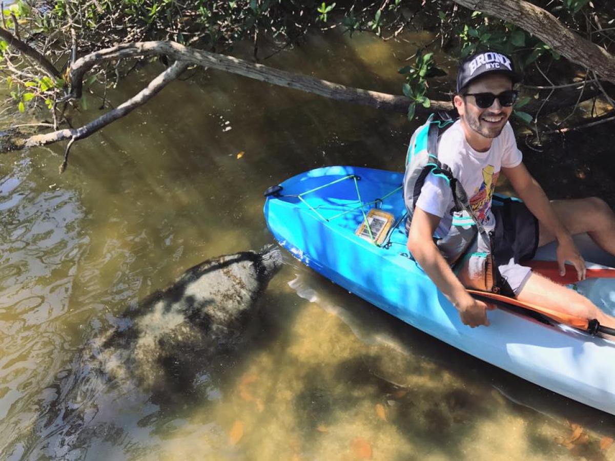 a man sitting on a raft in a body of water