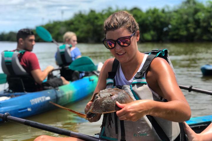 a group of people on a boat in the water