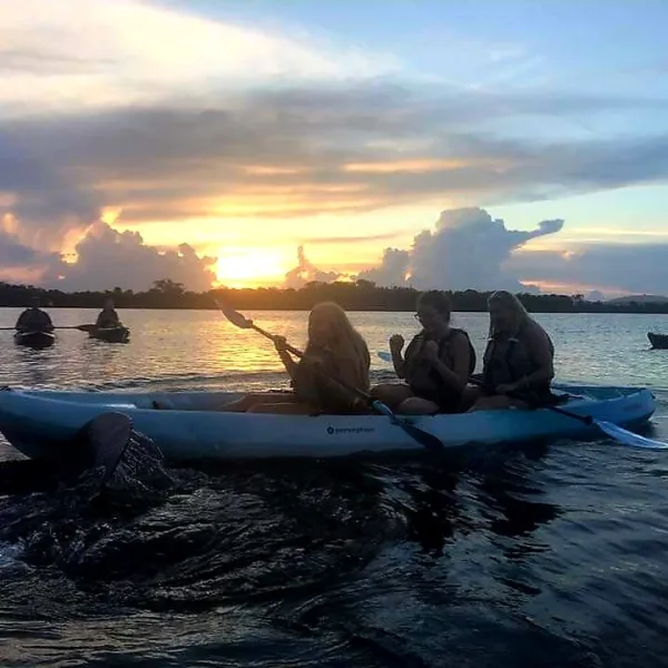 a group of people in a boat on a body of water
