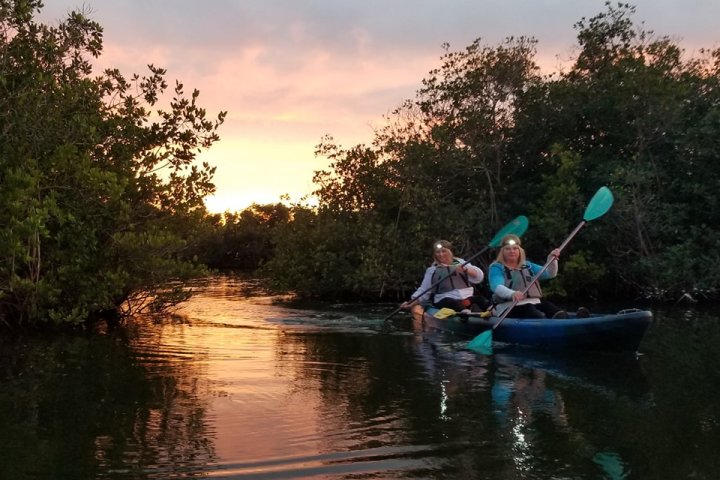a man riding on the back of a boat in the water