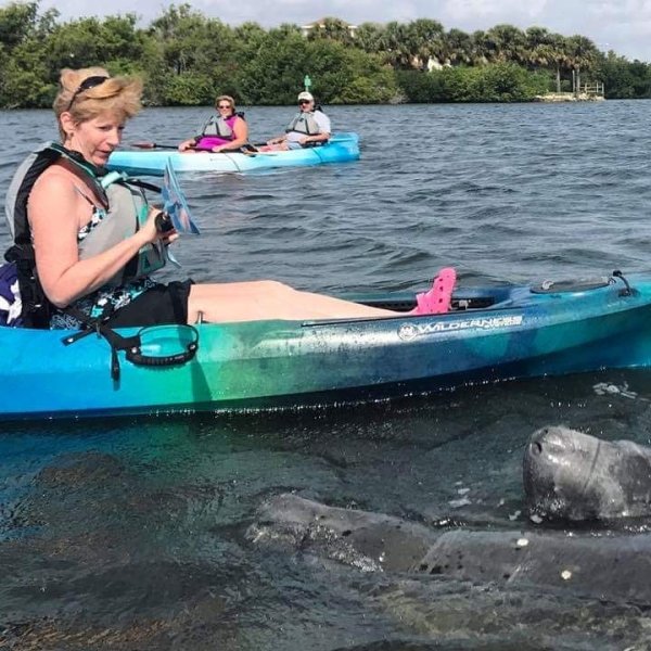 a group of people in a boat on a body of water