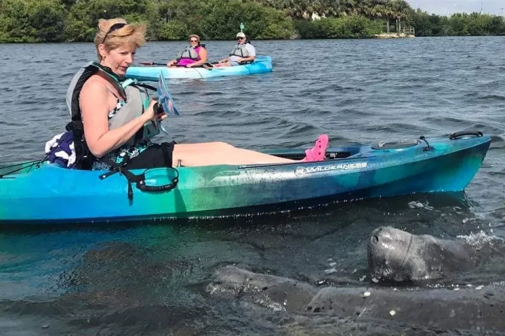 a group of people in a boat on a body of water