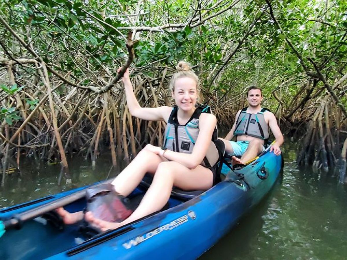 a young girl riding on the back of a boat
