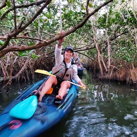 a man riding on the back of a boat in the water