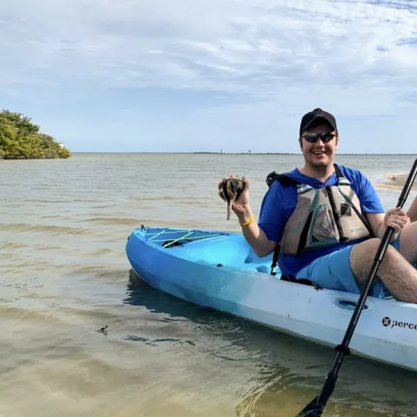 a group of people in a small boat in a body of water