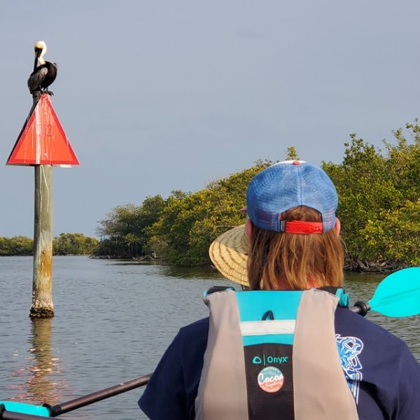 a person standing next to a body of water