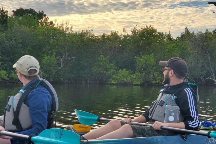 a group of people in a boat on a body of water