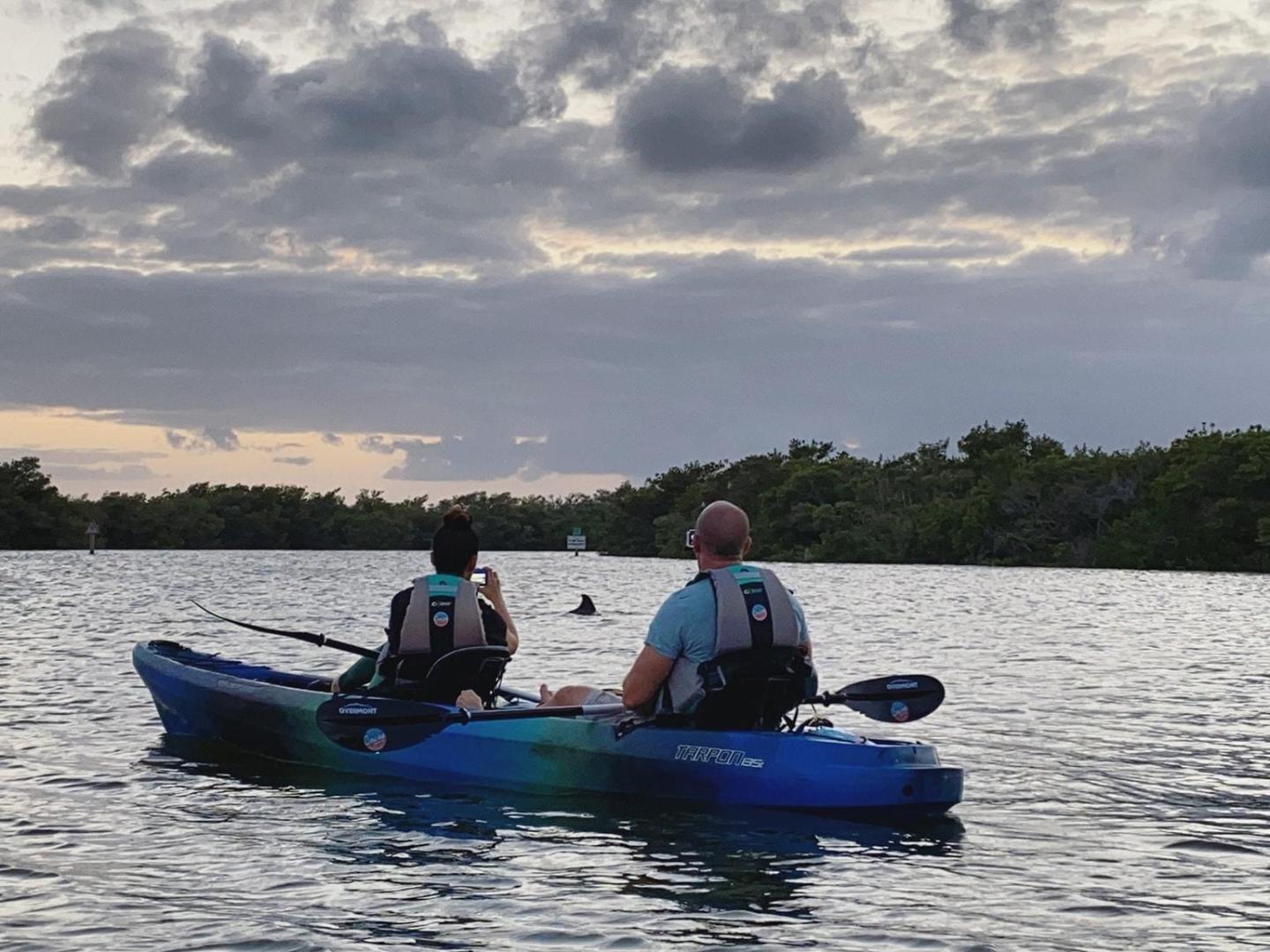 a man riding on the back of a boat in a body of water