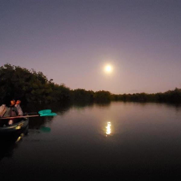 a man riding on the back of a boat in the water