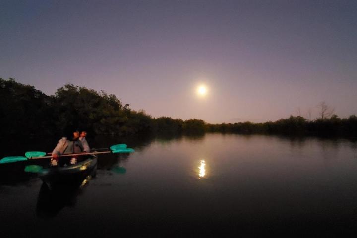 a man riding on the back of a boat in the water