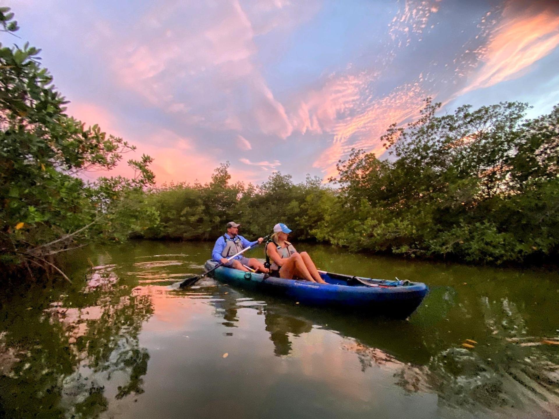 a man riding on the back of a boat in the water