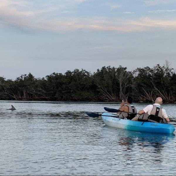a group of people in a boat on a body of water