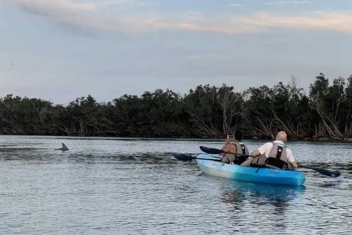 a group of people in a boat on a body of water