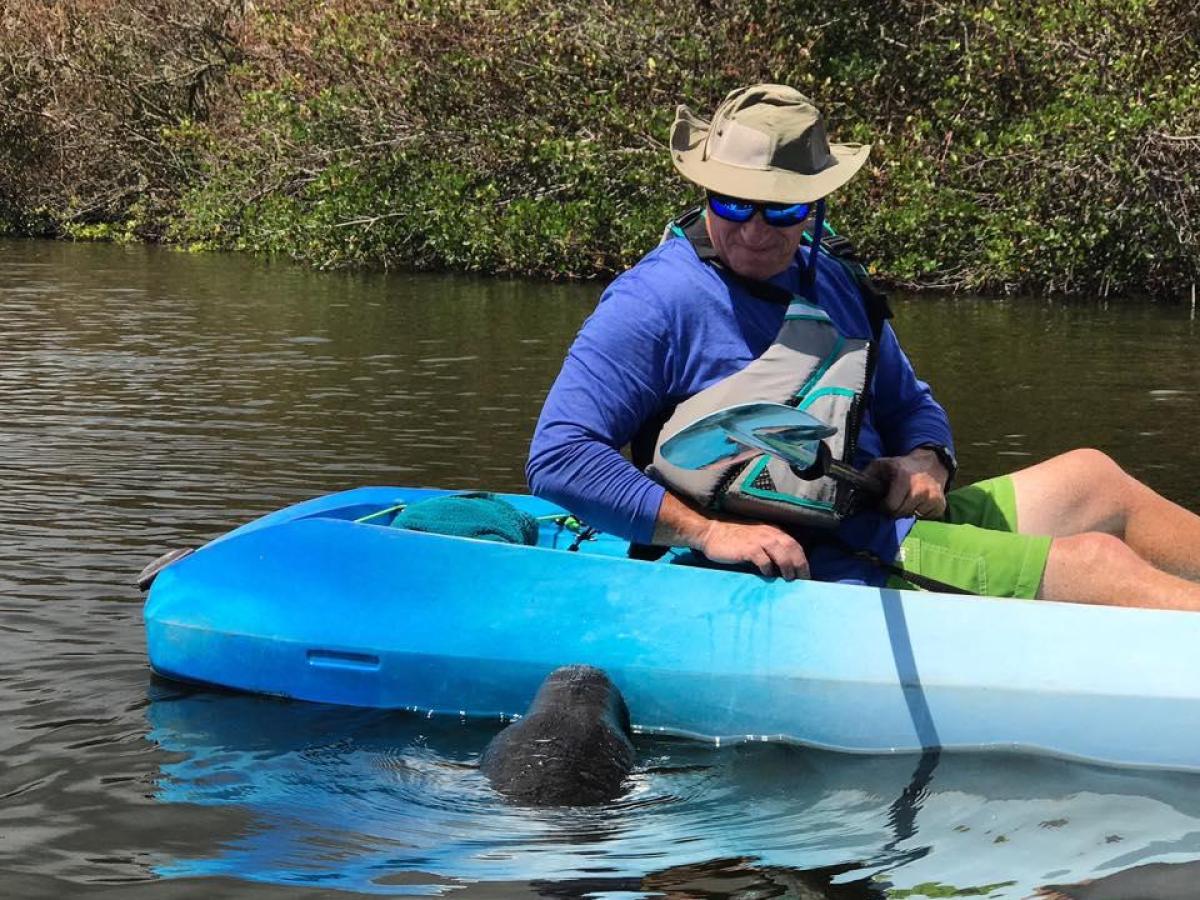 a person riding on the back of a boat in a body of water