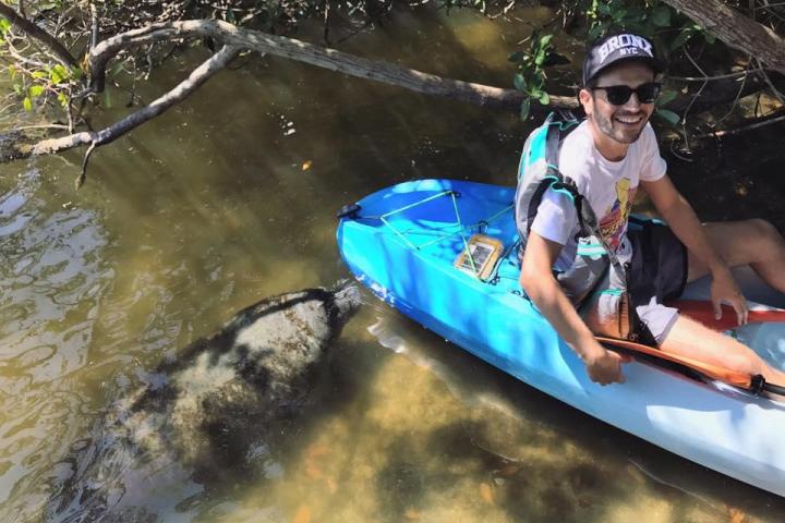a man sitting on a raft in a body of water