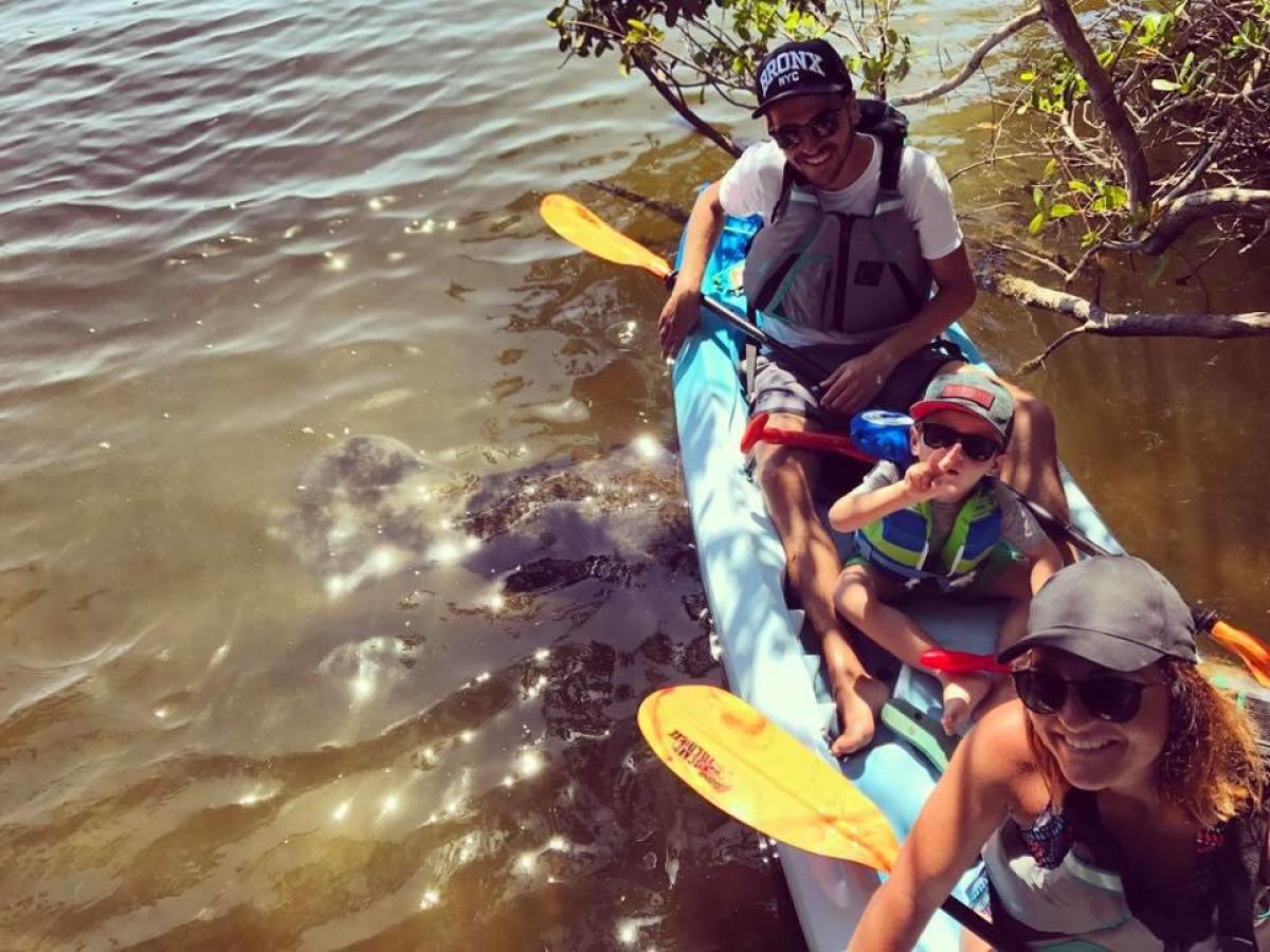 a man riding on the back of a boat in the water