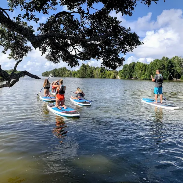a group of people riding on the back of a boat in the water