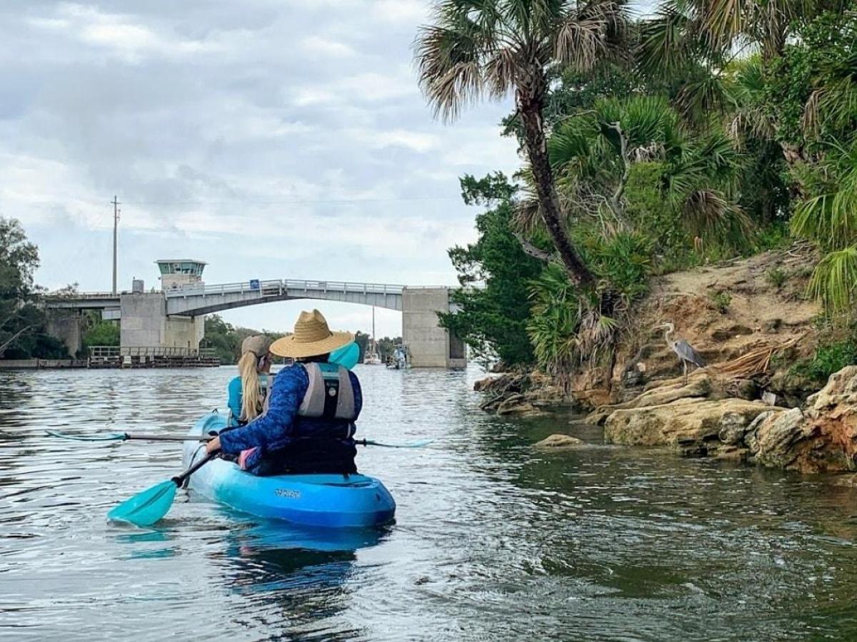 a person riding on the back of a boat in the water