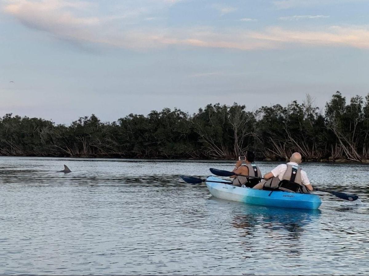 a group of people in a boat on a body of water