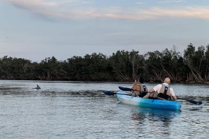 a group of people in a boat on a body of water