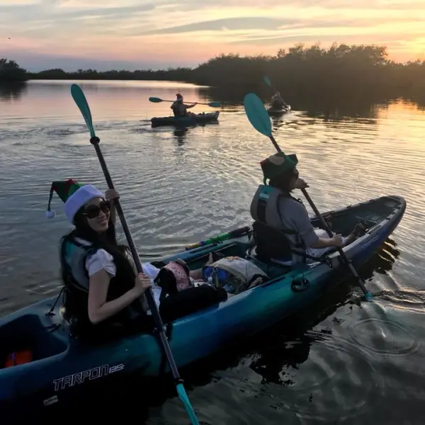 a group of people in a small boat in a body of water