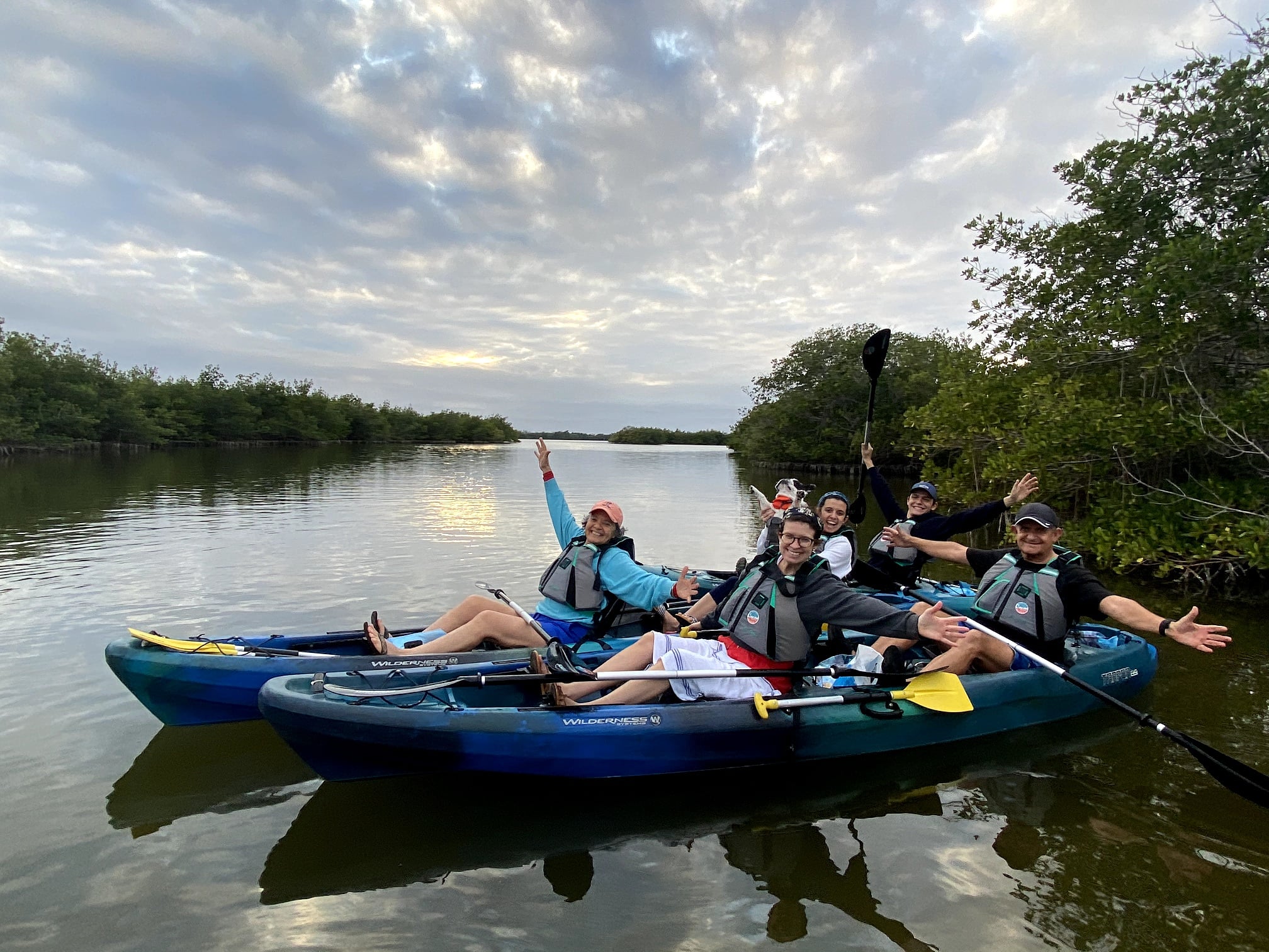 a group of people riding on the back of a boat in the water