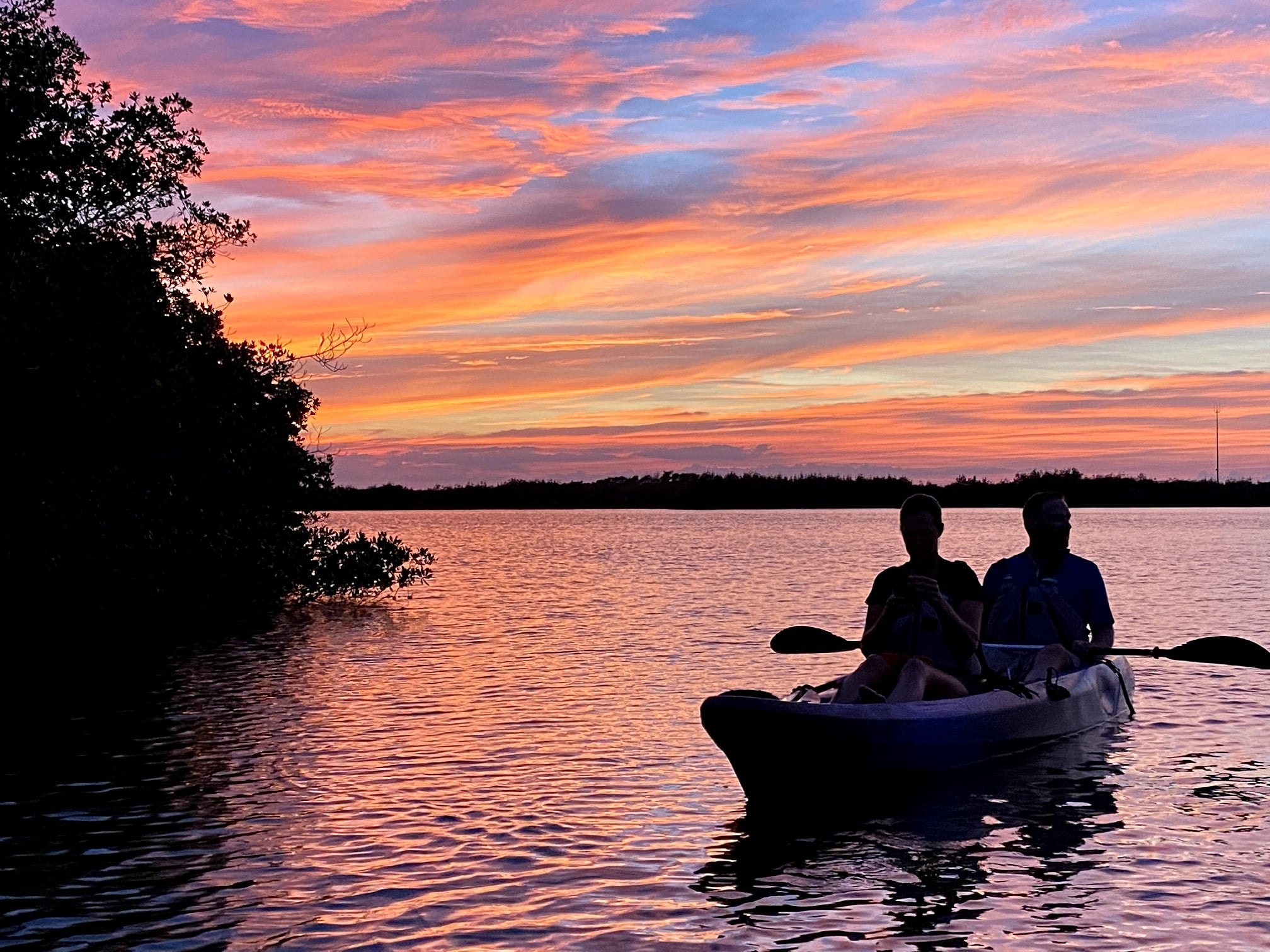 a man riding on the back of a boat in a body of water