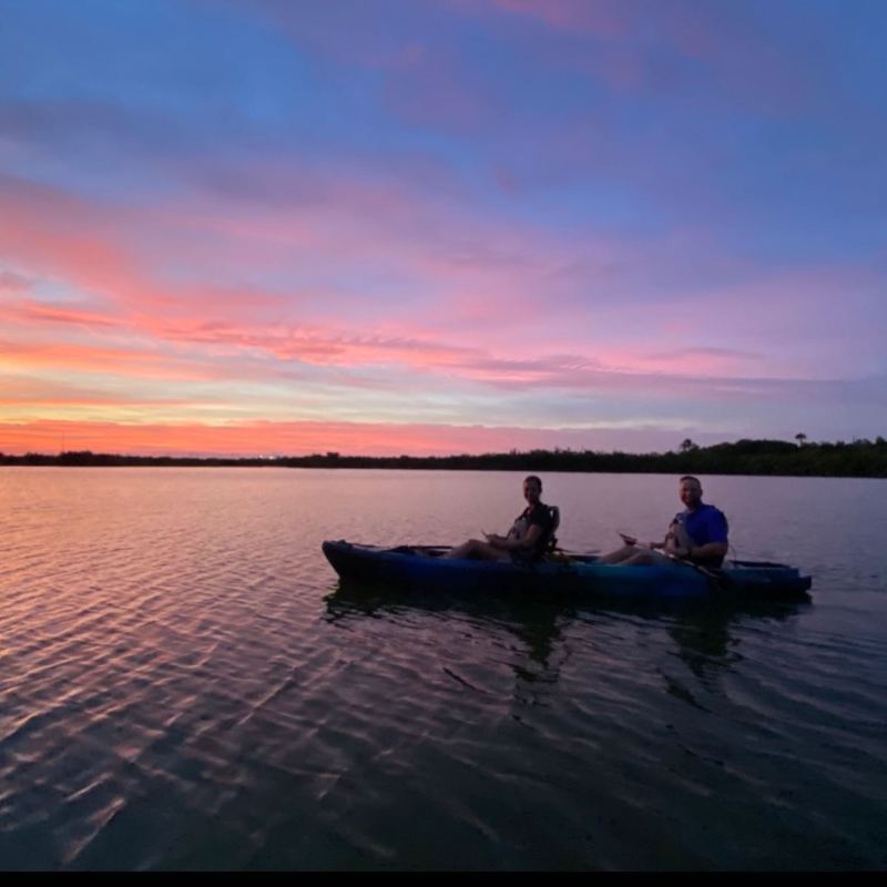 a group of people in a boat on a body of water