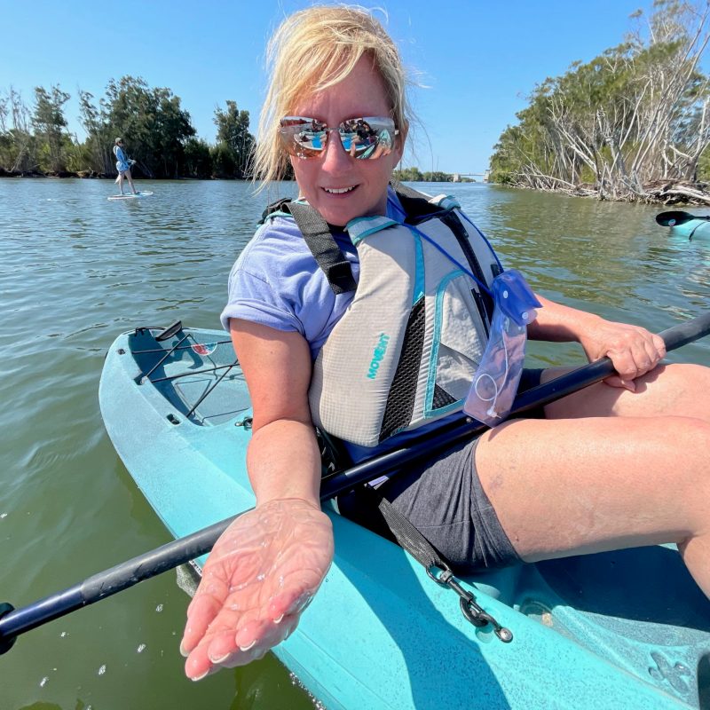 a person sitting on a boat in a body of water