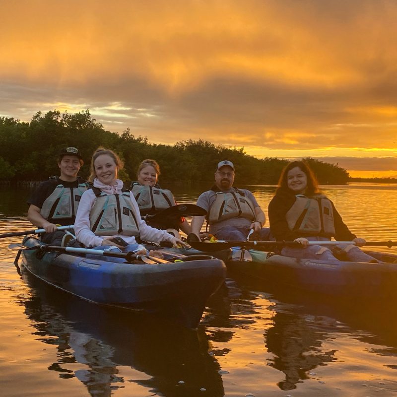 a group of people in a boat on a body of water