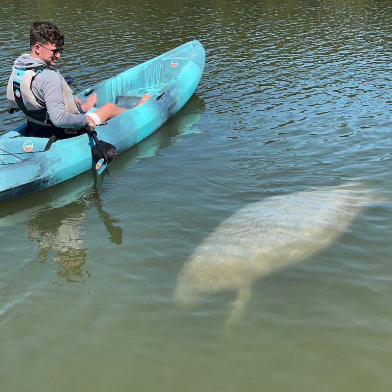 a man sitting on a boat in the water