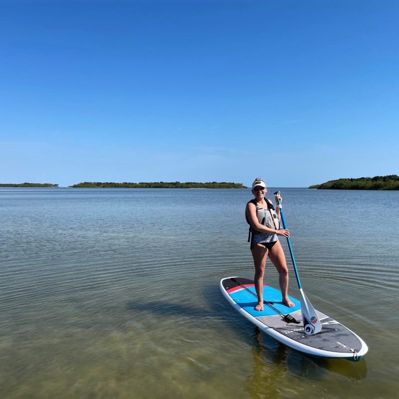a man standing next to a body of water