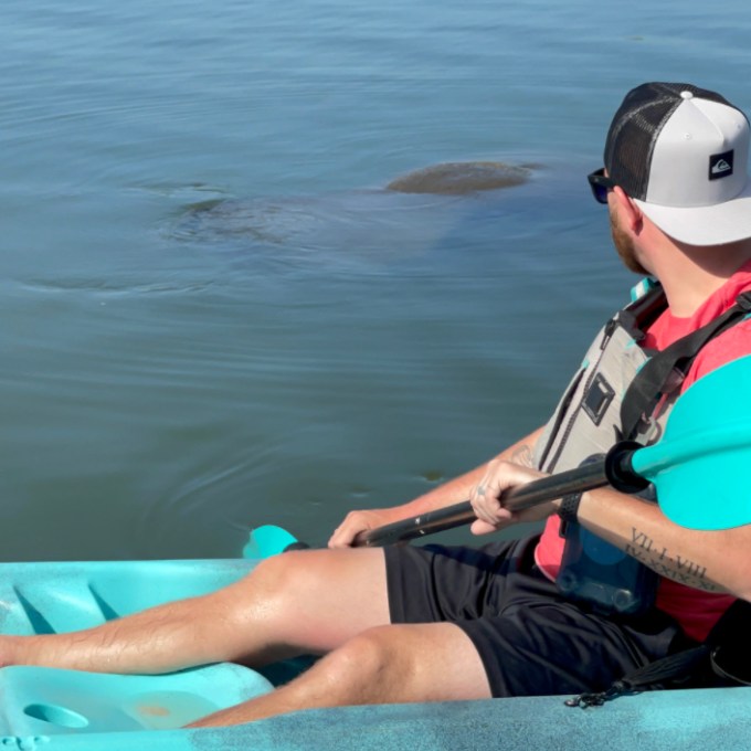 a person sitting next to a body of water