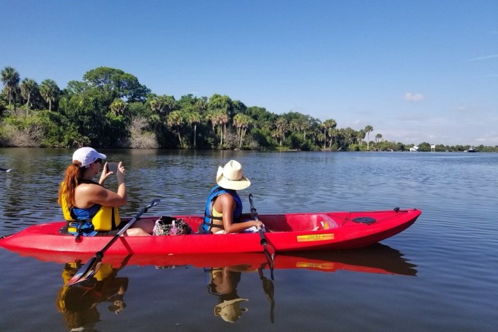 a group of people in a small boat in a body of water