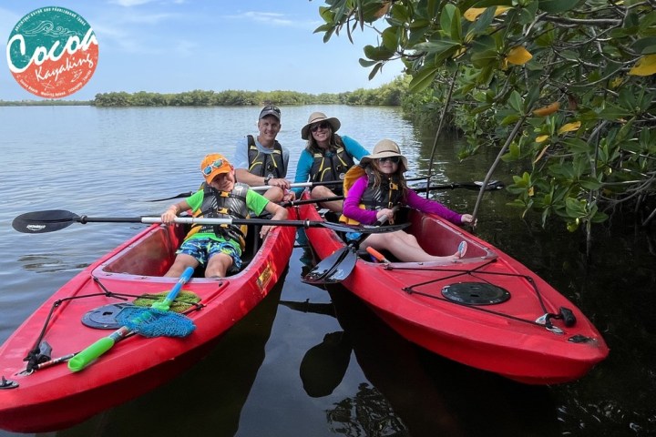 a group of people in a small boat in a body of water