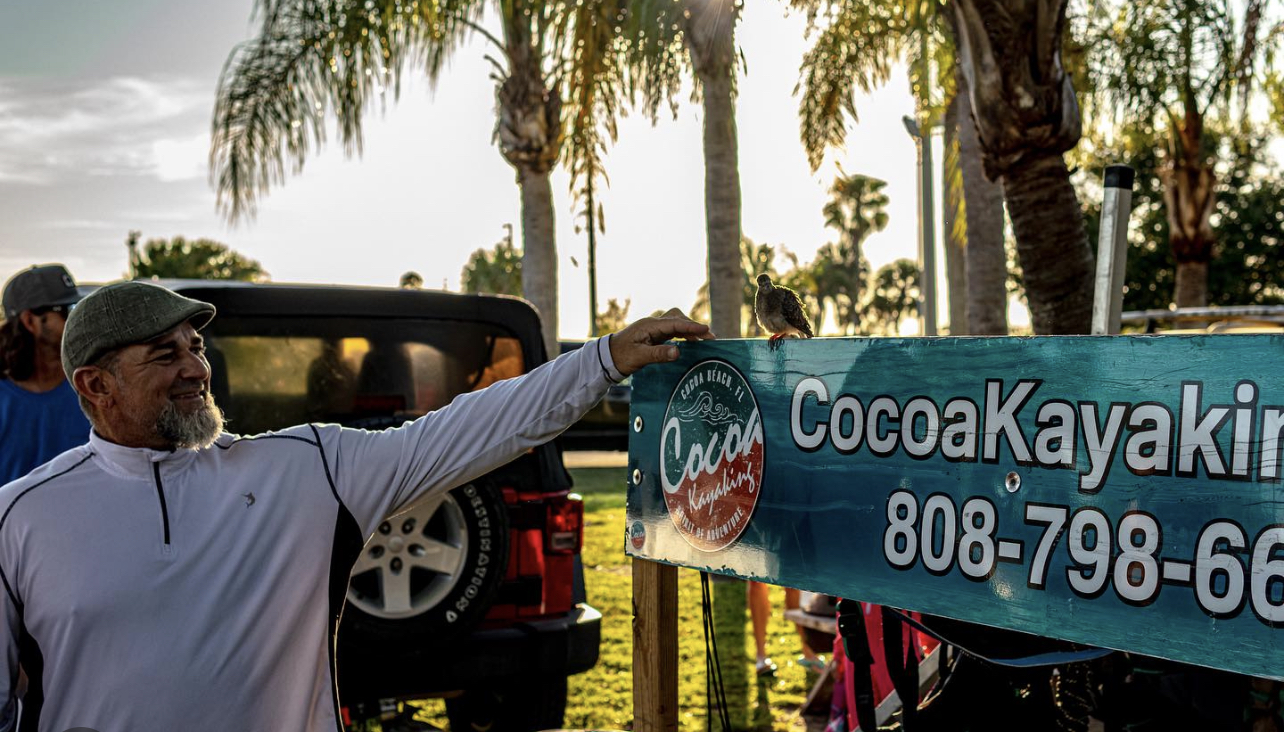 4D9C3237-8B58-43BA-9CDF-E45704793609 a man holding a sign