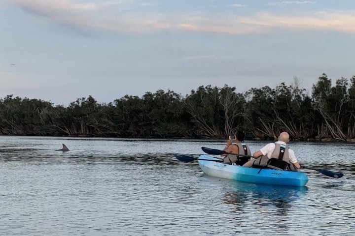 a group of people in a boat on a body of water