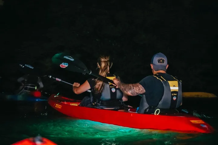 a person riding on the back of a boat