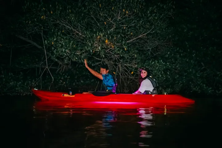 a man with a small boat in a body of water