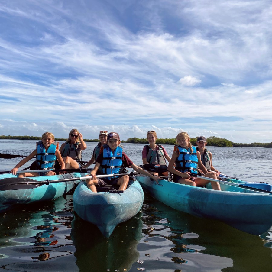 a group of people in a boat on a body of water