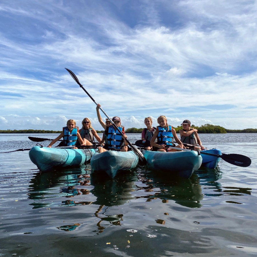 a group of people in a boat on a body of water