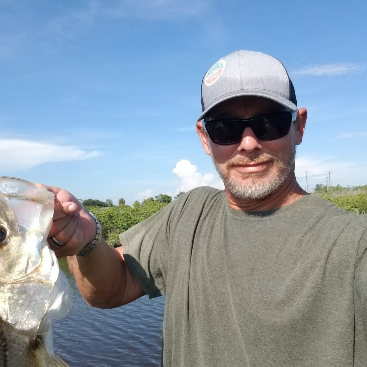 a man holding a fish in the water
