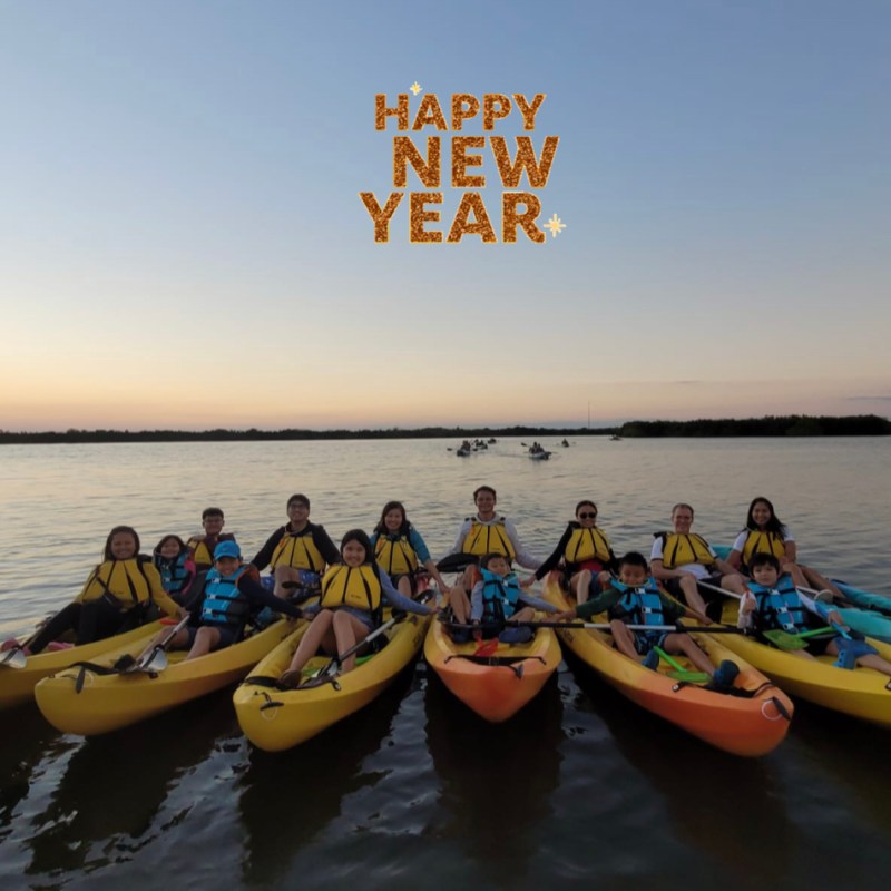 a group of people in a boat on a body of water