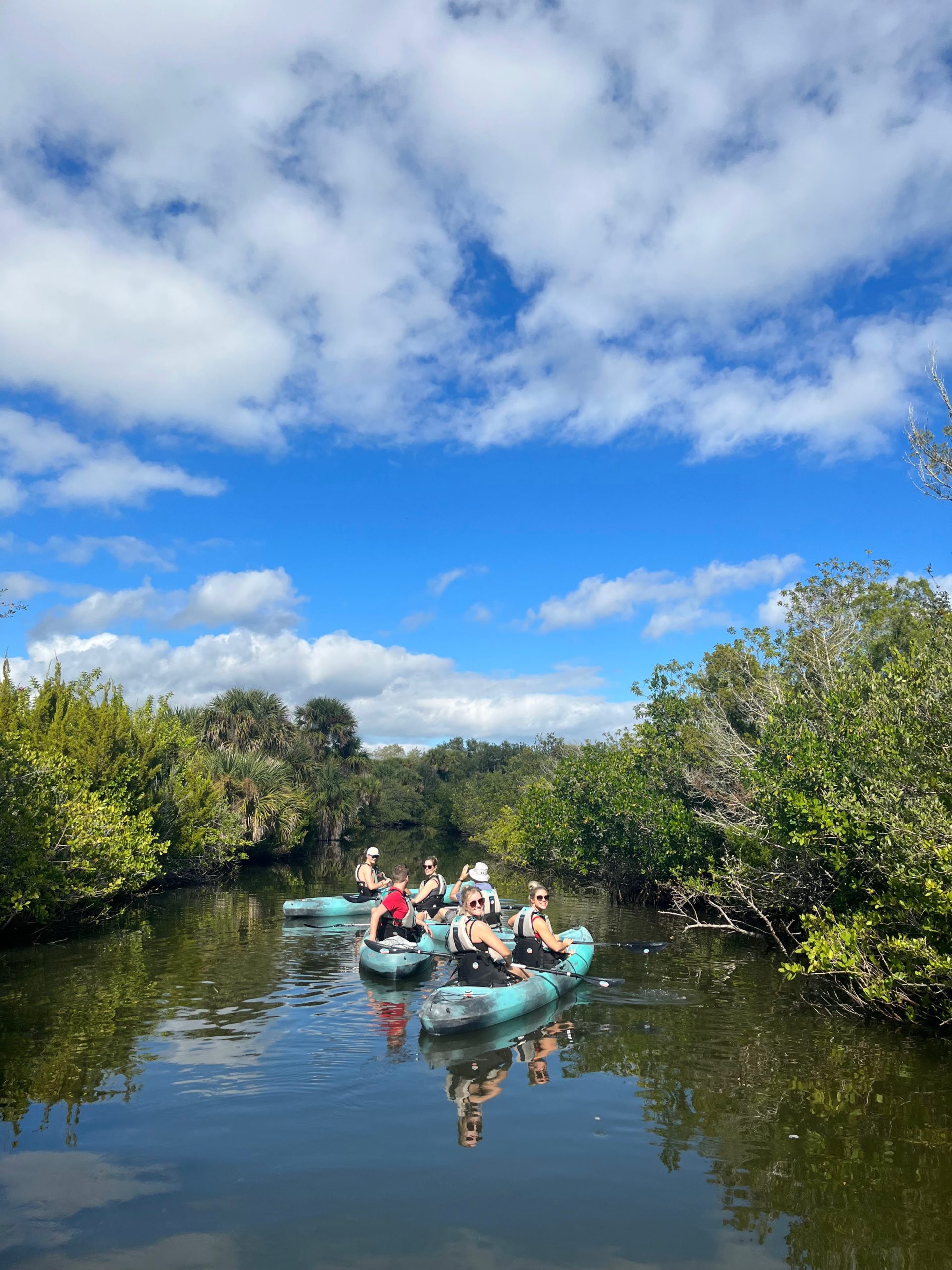 a group of people in a small boat in a body of water