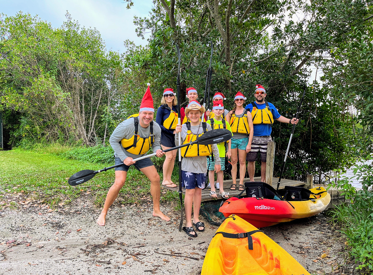 a group of people that are standing in the grass