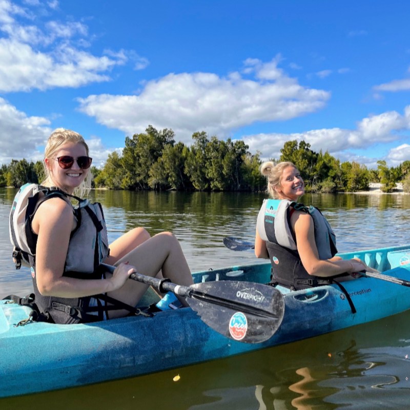a group of people in a boat on a body of water